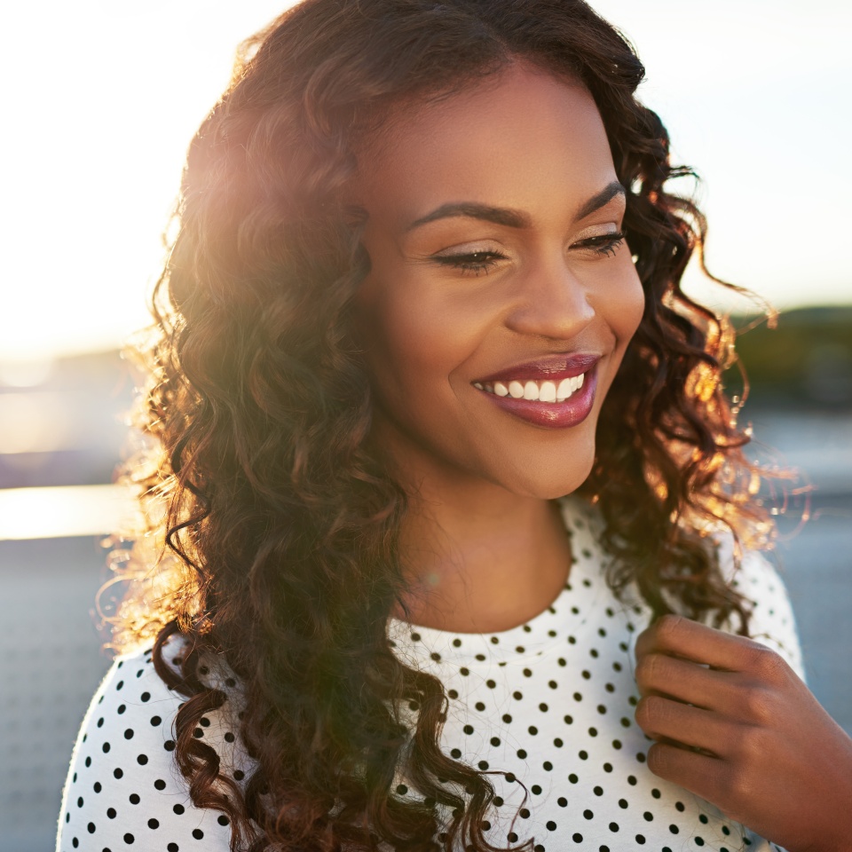 Beautiful afro american woman on a blurry background smiling