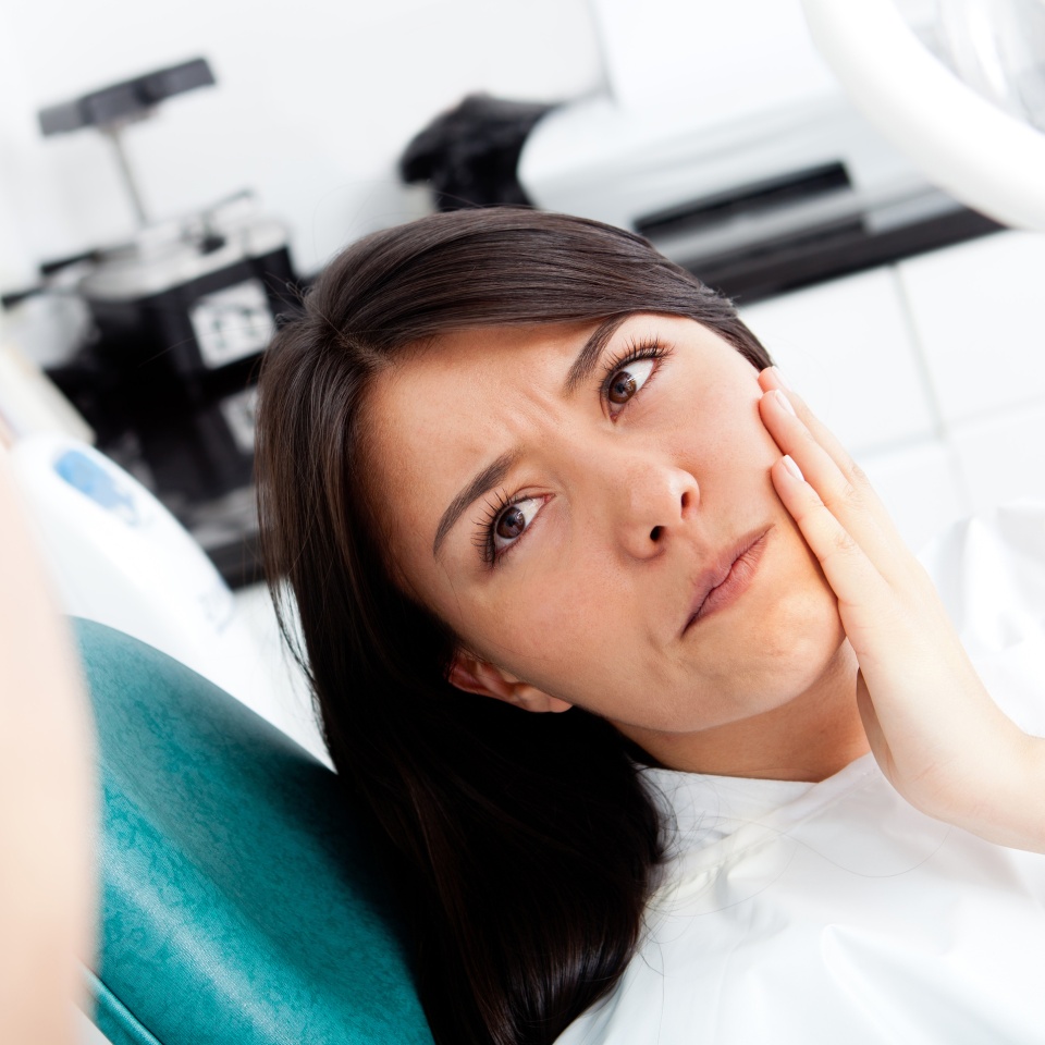 Woman at the dentist complaining about a tooth pain