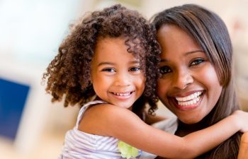 Happy portrait of a mother and daughter smiling
