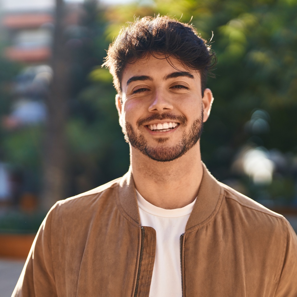 Young hispanic man smiling confident standing at park